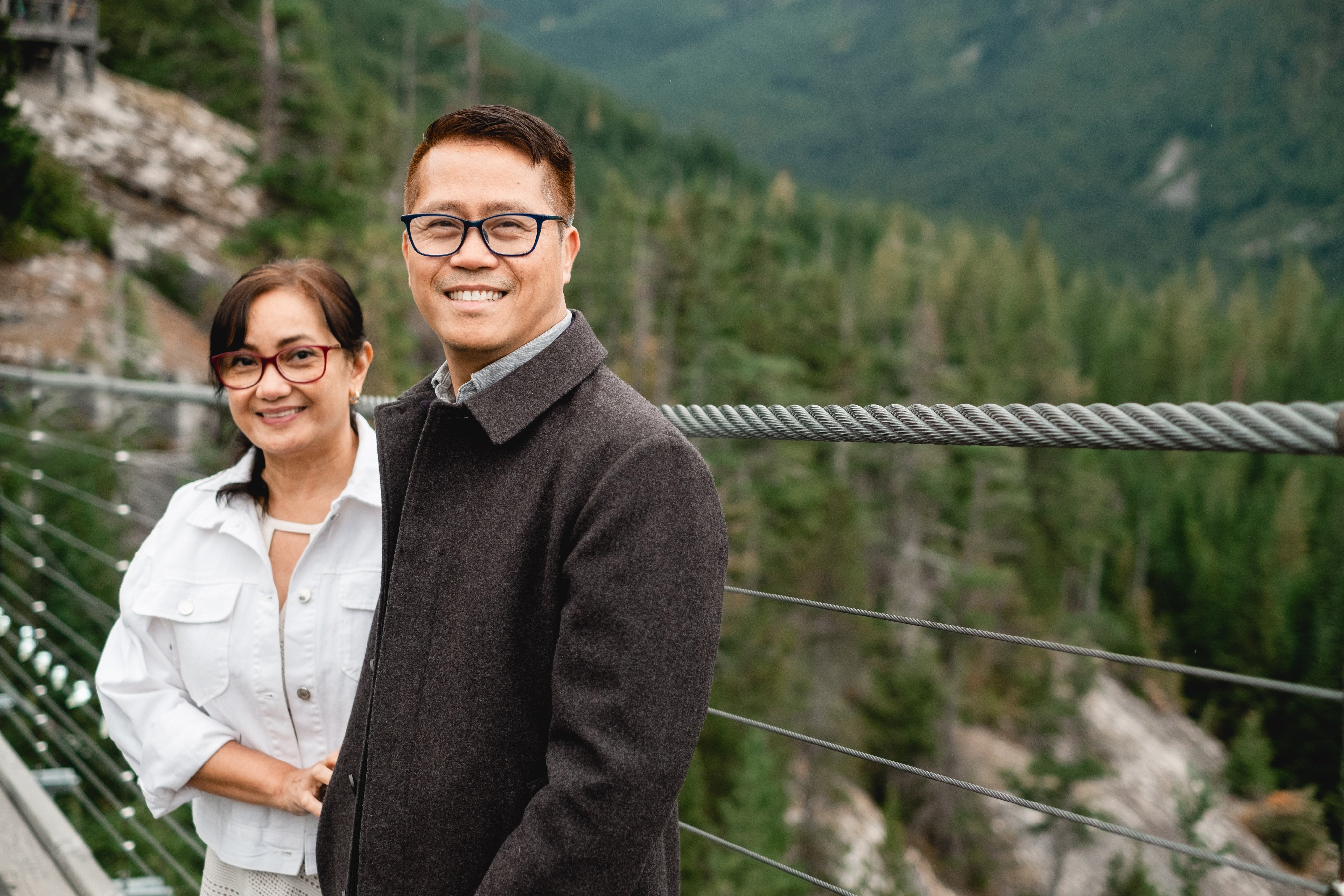 files/two-people-smiling-while-surrounded-by-dense-forest.jpg